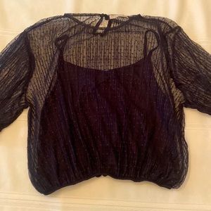 Black, subtly polka dotted blouse